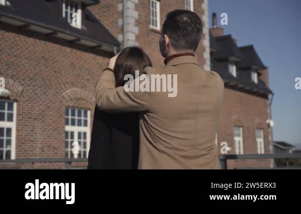 Wealthy Caucasian man opening eyes of surprised young woman showing new ...