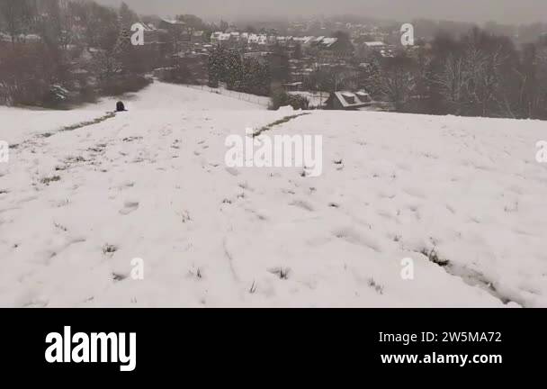 Rapid sleigh ride downhill in POV fun sledging through deep snow with ...