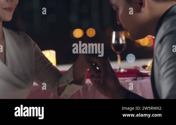 Young asian couple kiss moment with romantic dinner drinking wine in ...