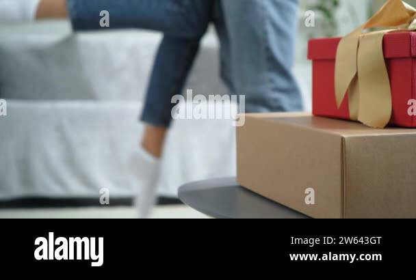 Close-up gift boxes lie on table partners spouses hugging wife hanging ...