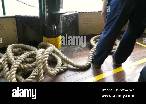 Sailor tidying rope as iconic Star Ferry leaves pier on Kowloon side of ...
