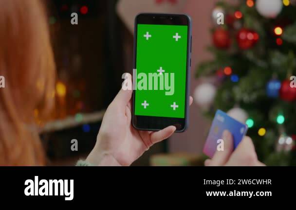 Close up of woman hand holding a mobile phone with a vertical Green ...