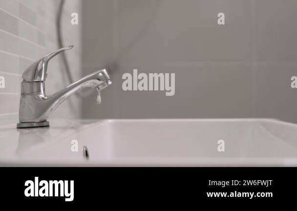 faucet in the bathroom with running water. keeps turning off the water ...