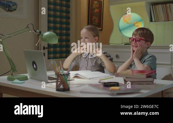 Brother and sister remote learning from home. Children talking to ...
