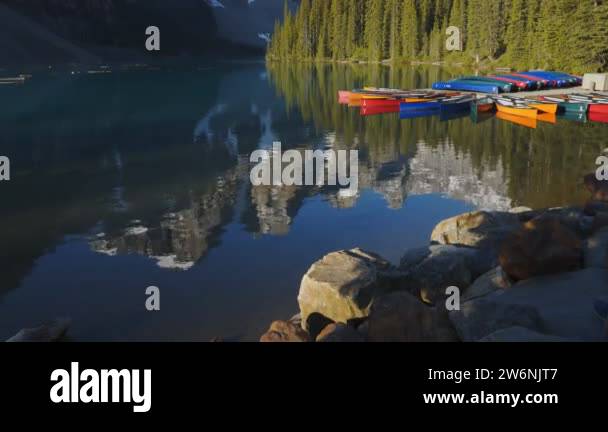 Banff Dock shot of moraine lake and canoes at a dock in banff national park Stock ...