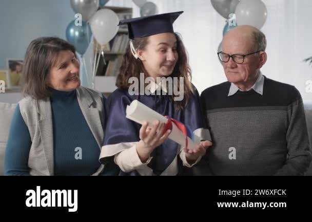 portrait happy family with graduate daughter in an academic cap and ...