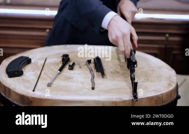 Process of assembly of the Kalashnikov rifle. Video. Close up of man ...