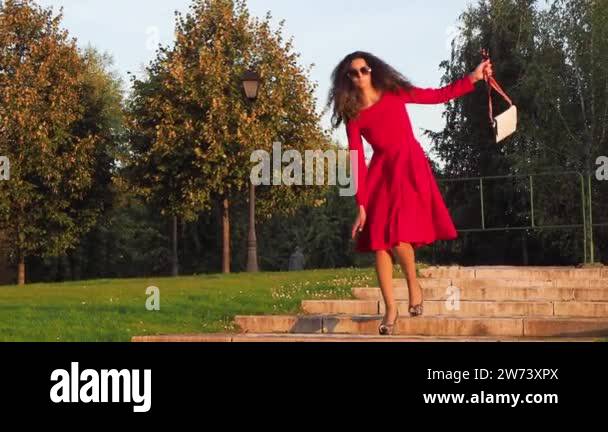 drunk woman in heels awkward walking down stairs in park Stock Video ...
