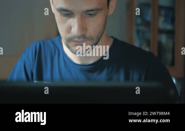 Young attractive guy working on his laptop. Young guy programmer ...