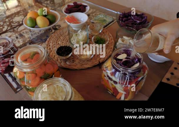 Fermenting, preserving vegetables, finishing a jar by adding water with