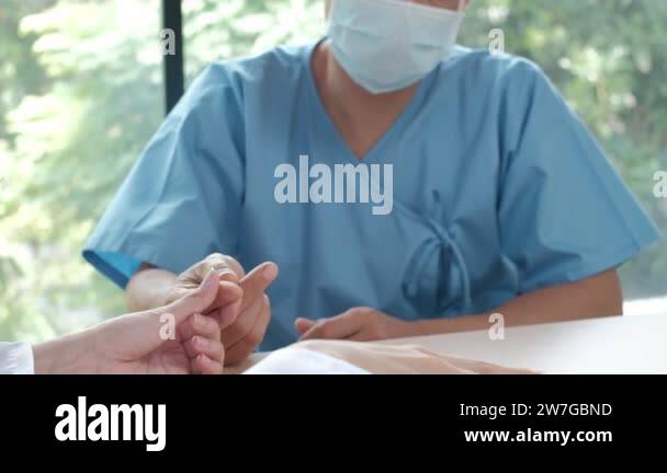 Female doctor exam the blood of a male Asian patient by insulin meter ...