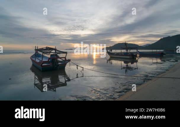 Timelapse view sunset over fishing boat Stock Video Footage - Alamy
