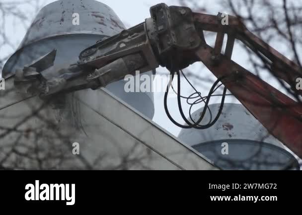 Demolition equipment crunching the concrete in the bridge into tiny ...