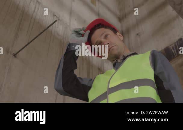 Low angle locked-down of blue-eyed Caucasian construction worker ...