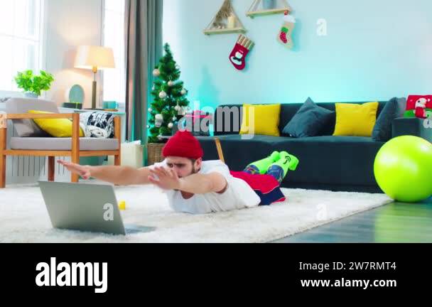 Workout at home on the floor in the living room guy doing some
