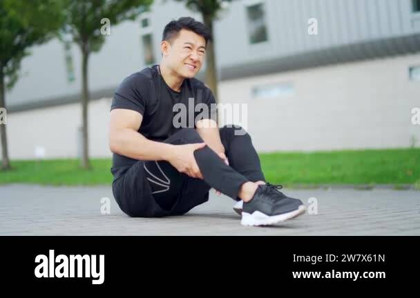 young asian runner athlete with muscle pain. Man massaging Stretching ...