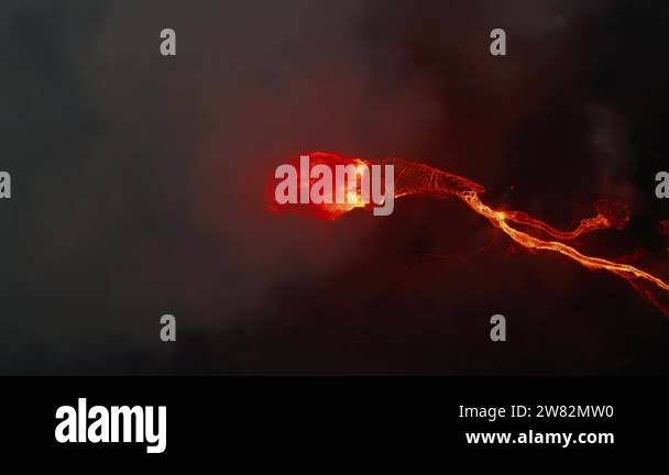 Night aerial view of active volcano crater and lava show. Flowing ...