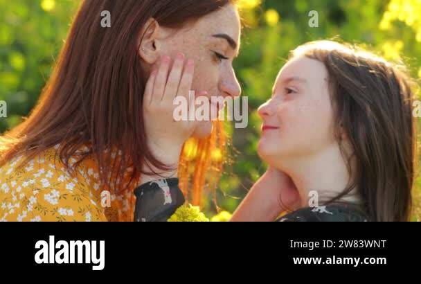 redhead mom with her daughter. little girl strokes momy hand. freckles ...