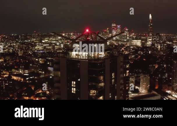 Fly around roof lookout terrace at tall apartment building. Night scene ...