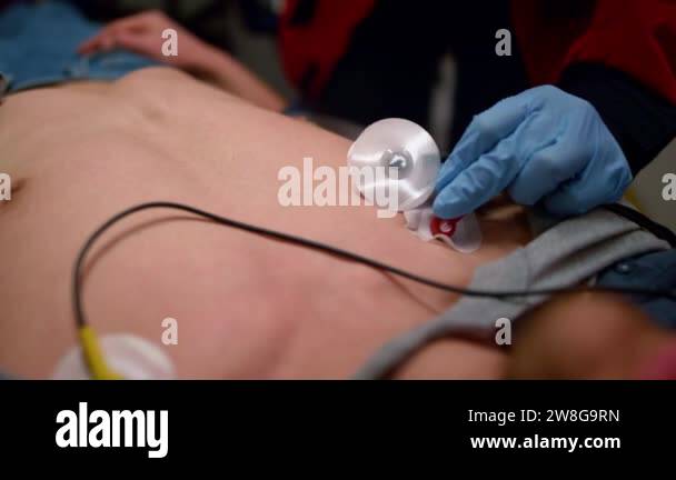 Ecg Sensor Inhand Emergency doctor hands applying sensors to measure man ECG Stock Video ...