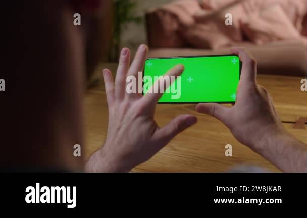 Handheld Camera: Back View of Man at Phone with Green Screen for Copy ...