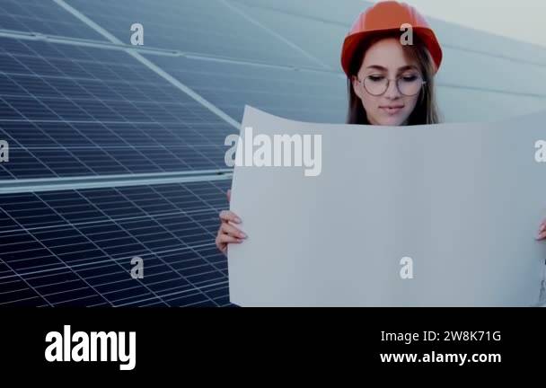 Handsome Architect Woman Examining a Draft Map or Blueprint Project ...