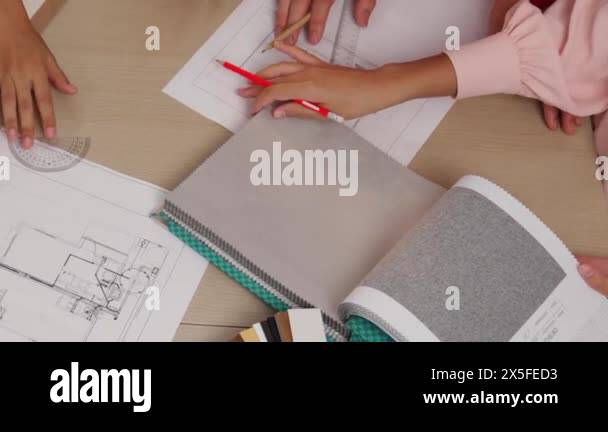 Slow motion interior designer drafting blueprint with customer ...