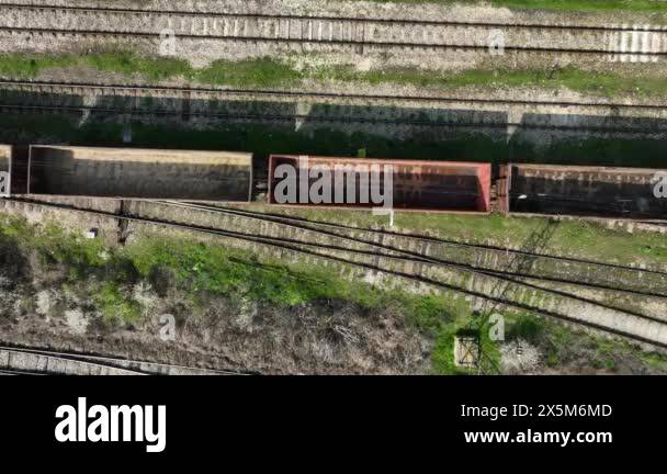 Aerial view of a freight train with empty containers. Empty wagons of a ...