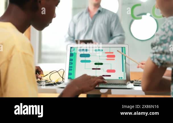 Back view of diverse student coding system while girl pointing at ...