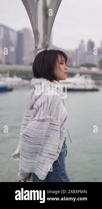 Capturing a serene scene, a woman in her twenties stands ...