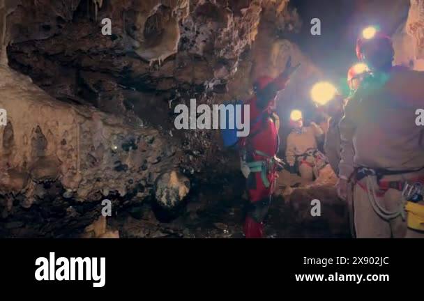 Burgos, Spain - May 19, 2024: A spelunker instructor guiding a group of ...