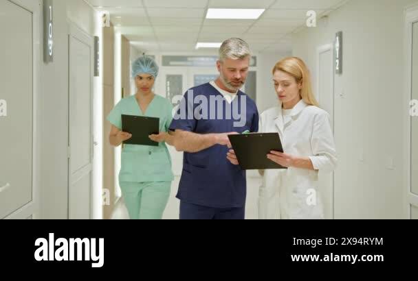 Medical professionals reviewing patient information on clipboards in a ...