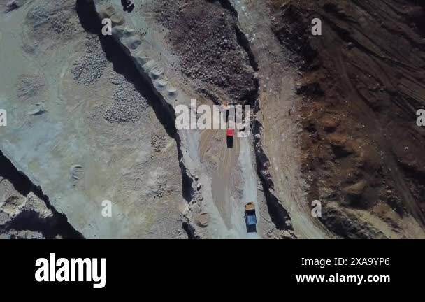 Yellow Excavator Loading Soil Into A Dumper Truck On Construction Site