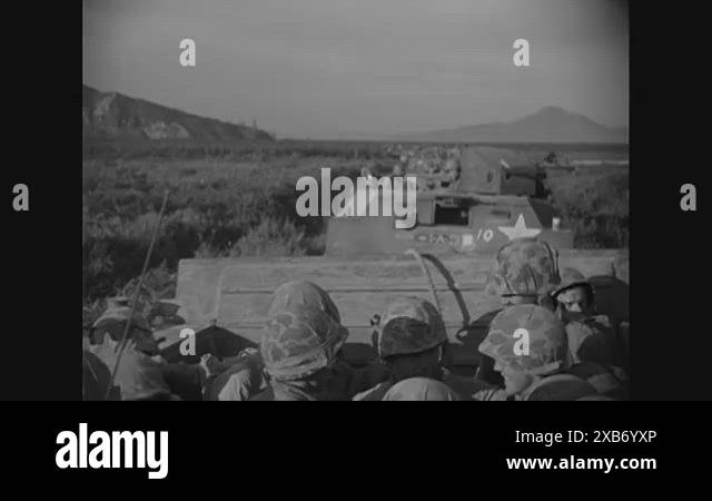 1950 - Marines in amphibious combat vehicles wait in a Korean village ...
