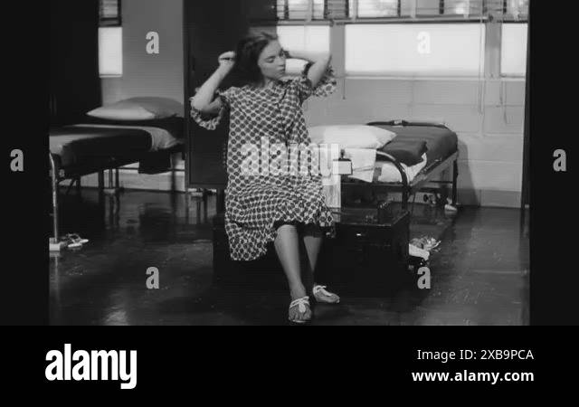 A private in the Women's Army Corps brushes her hair, brushes her teeth ...