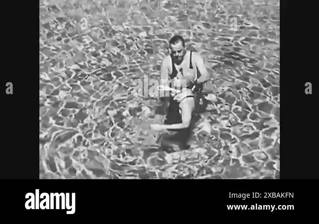 A water safety instructor assists a beginning swimmer as she floats on ...