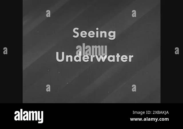 A beginning swimmer practices seeing underwater, in seawater, during a ...
