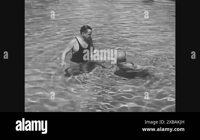 A beginning swimmer swims on her back, in seawater, during a swimming ...