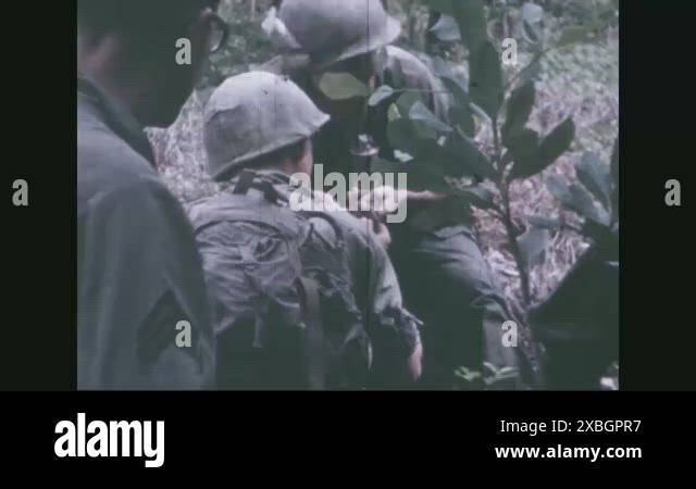 1969 - American soldiers eat C rations and advance through the jungle ...