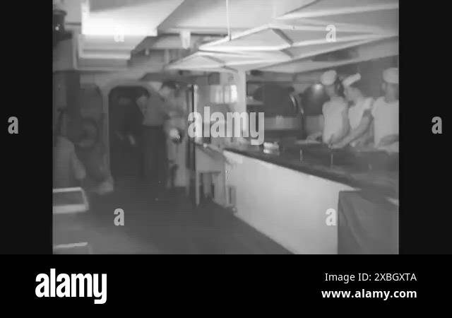 Enlisted men going through chow in the mess hall aboard the USS Siciliy ...