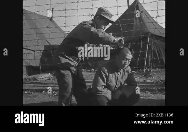 1951 - Korean POWs get their heads shaved at a prison camp Stock Video ...