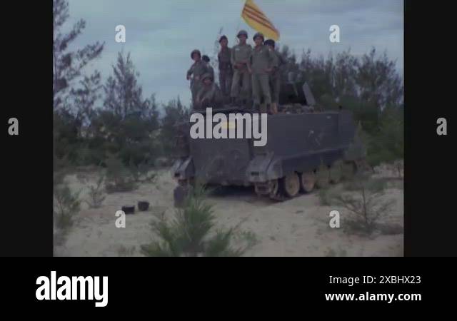 Move Inland Sign South Vietnamese soldiers pose on an armored vehicle and a soldier is ...