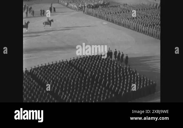Officers ride horses and salute and troops are shown during a military ...