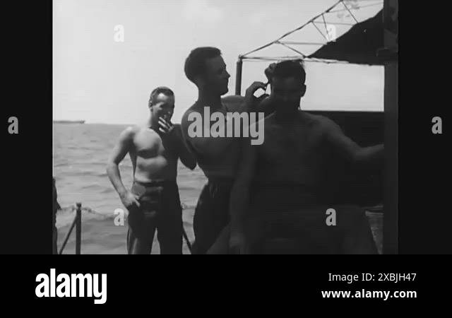 1944 - One US Navy seaman gives a haircut to another. Their fleet heads ...