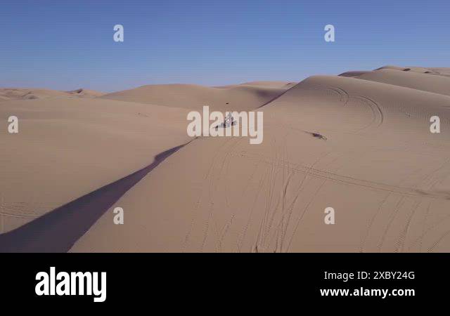 Dune buggies and ATVs race across the Imperial Sand Dunes in California ...