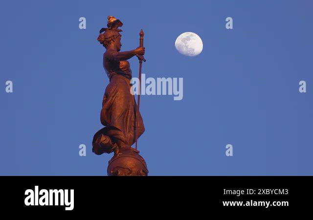 Statue atop Soldiers and Sailors Monument with moon rising in downtown ...