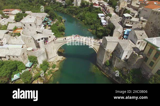 A bird's-eye-view shows the Mostar Bridge and the Neretva River it ...