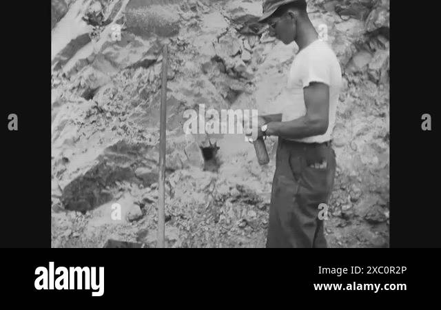 1951 - A US Army engineer wires a fuse for an explosive charge and