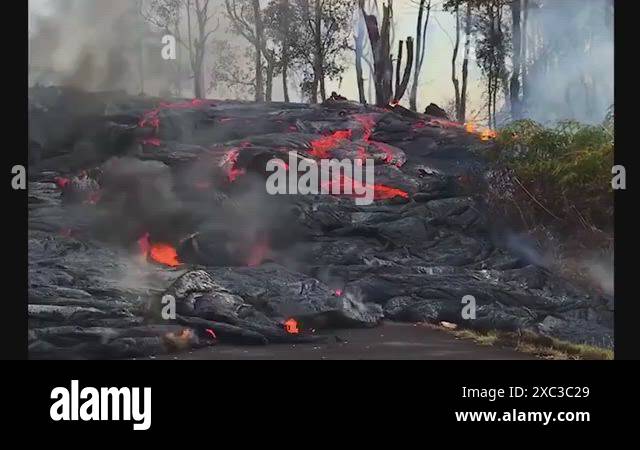 Spectacular night time flow of lava down a slope in Hawaii during the