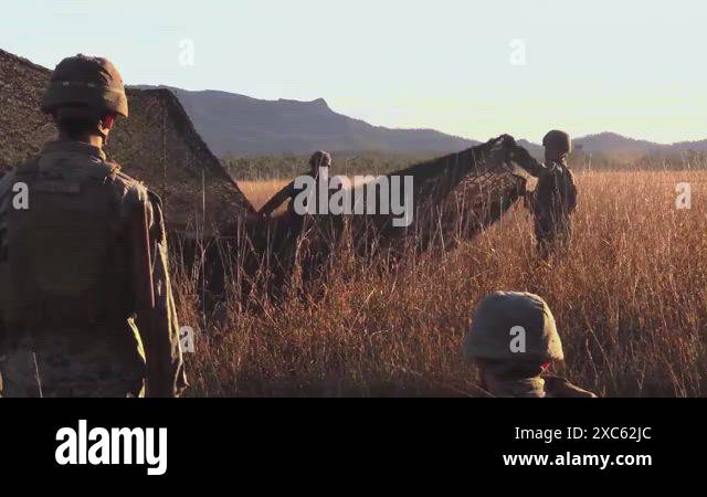 Australian Defense Force soldiers and U.S. Marines set up and fire ...